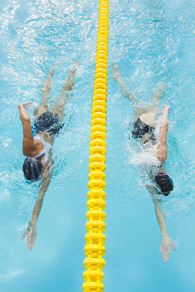 Women swimming laps in pool