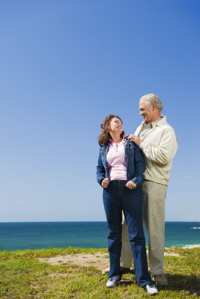 Couple standing near the ocean
