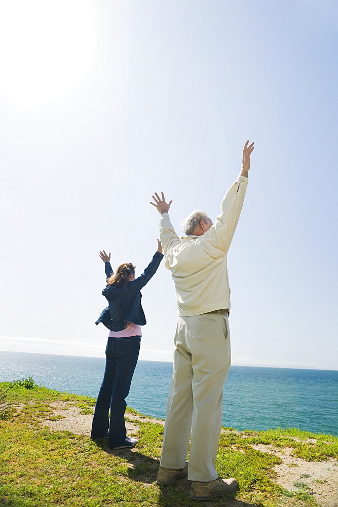 Couple raising their arms