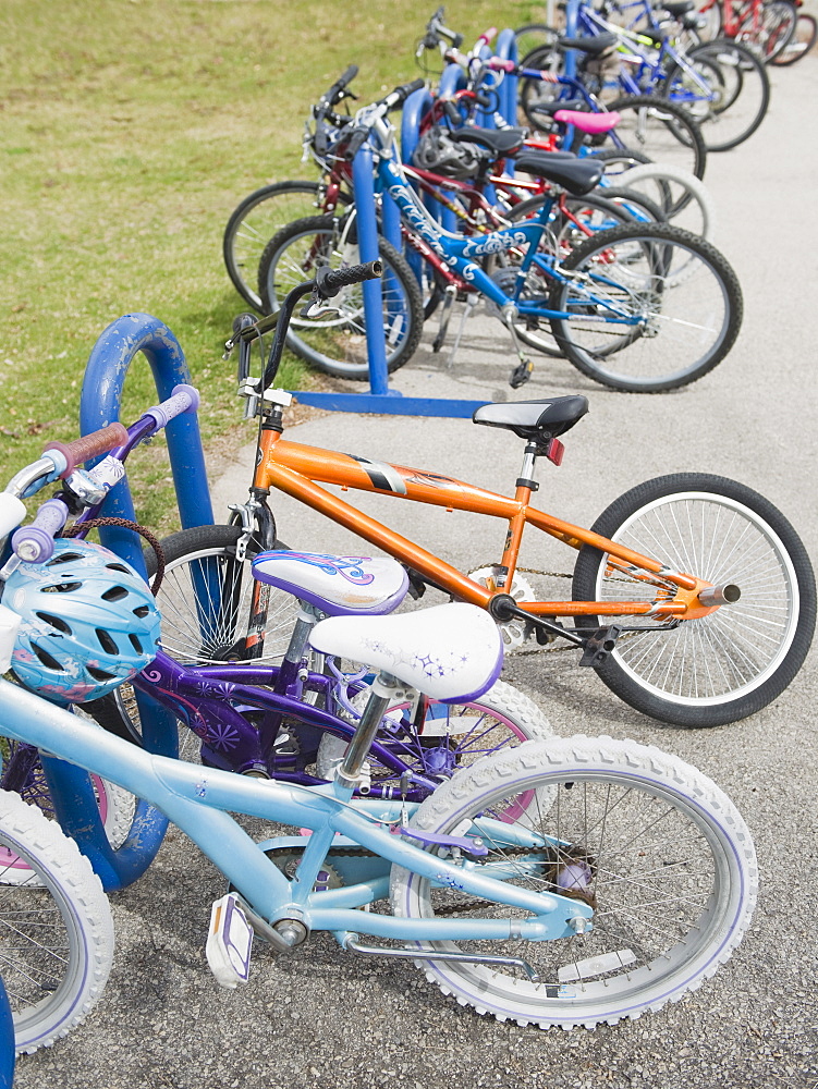 Row of children's bicycles locked up in school yard