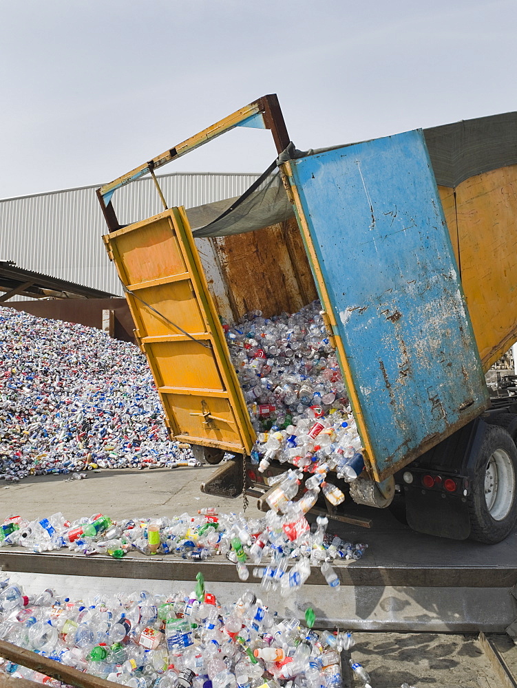 Recycle truck dumping out plastic bottles