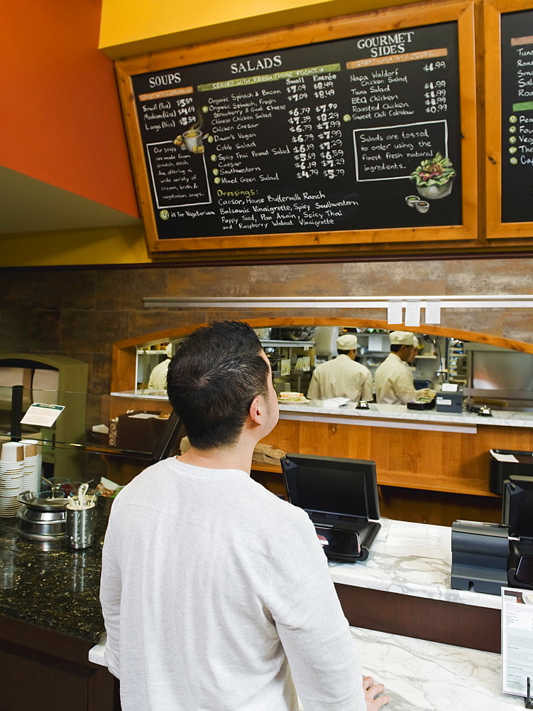 Customer reading chalkboard menu