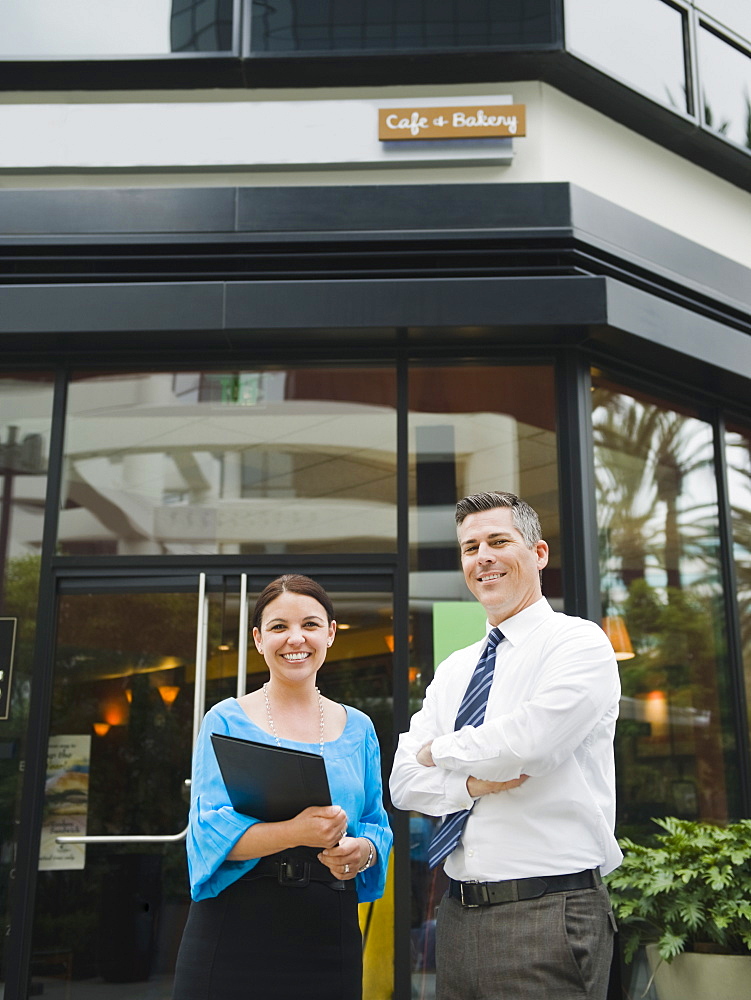 Business owners standing in front of building