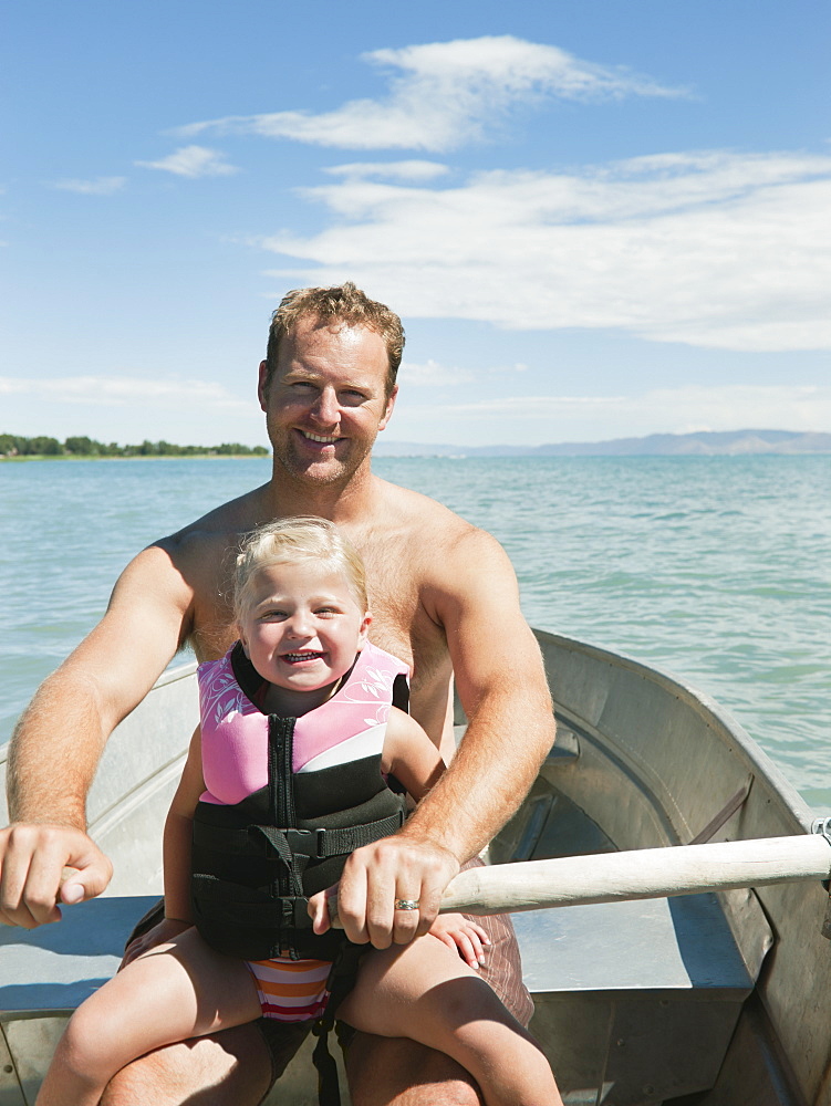 Father and daughter (2-3) on boat