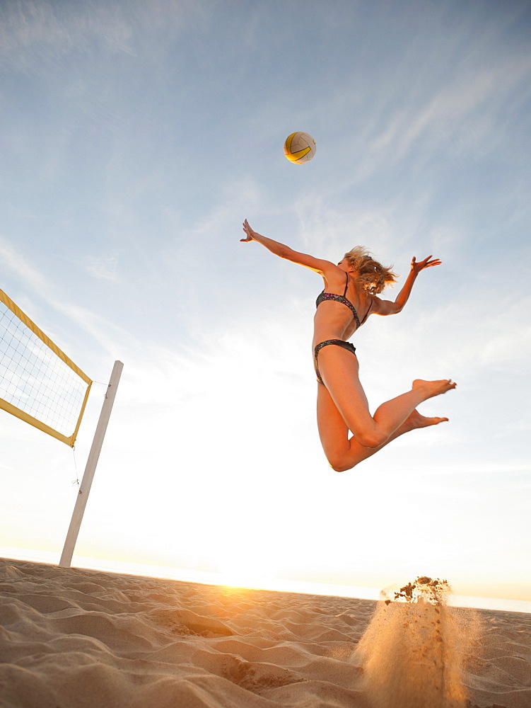 USA, California, Los Angeles, woman playing beach volleyball