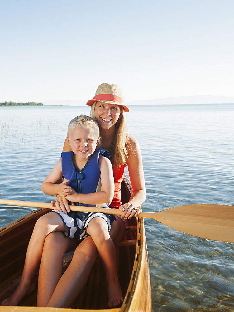 Portrait of young woman with son (4-5) canoe traveling