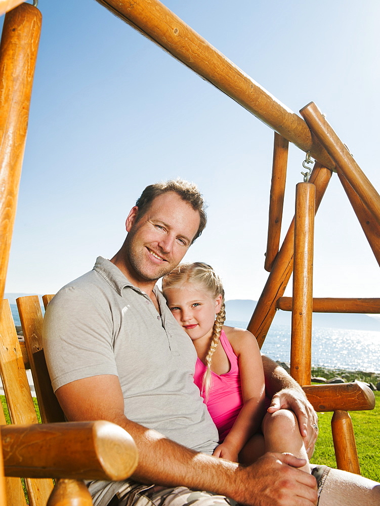 Portrait of father with daughter (4-5) on swing, USA, Utah, Garden City