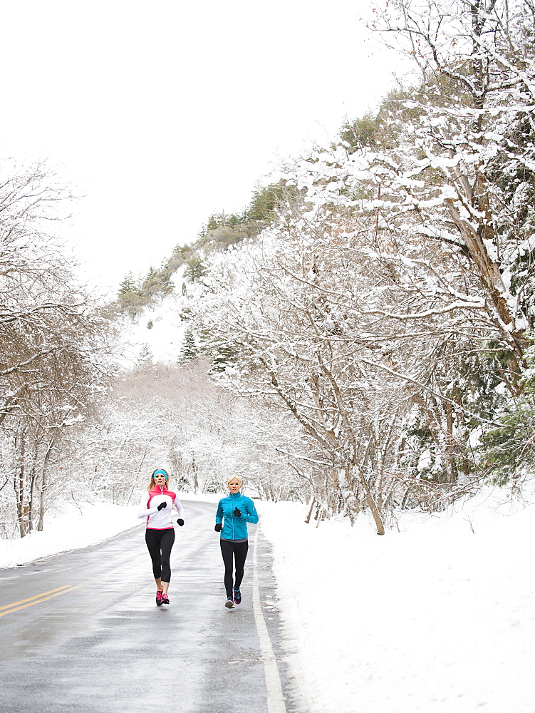 Two women jogging in winter, Salt Lake City, Utah USA