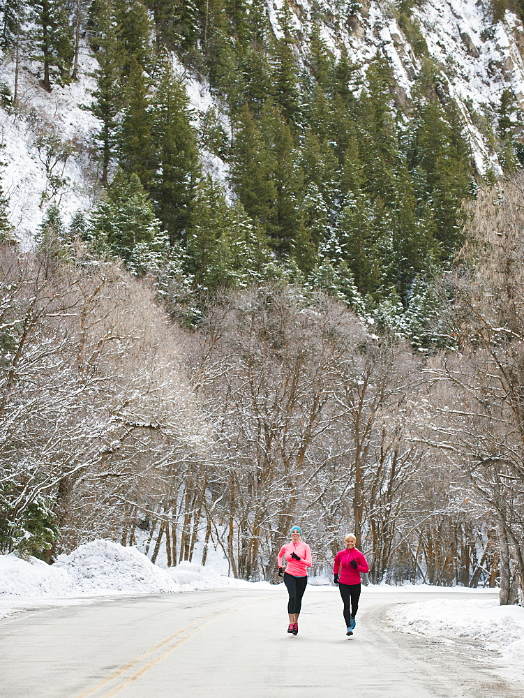 Two women jogging in winter, Salt Lake City, Utah USA