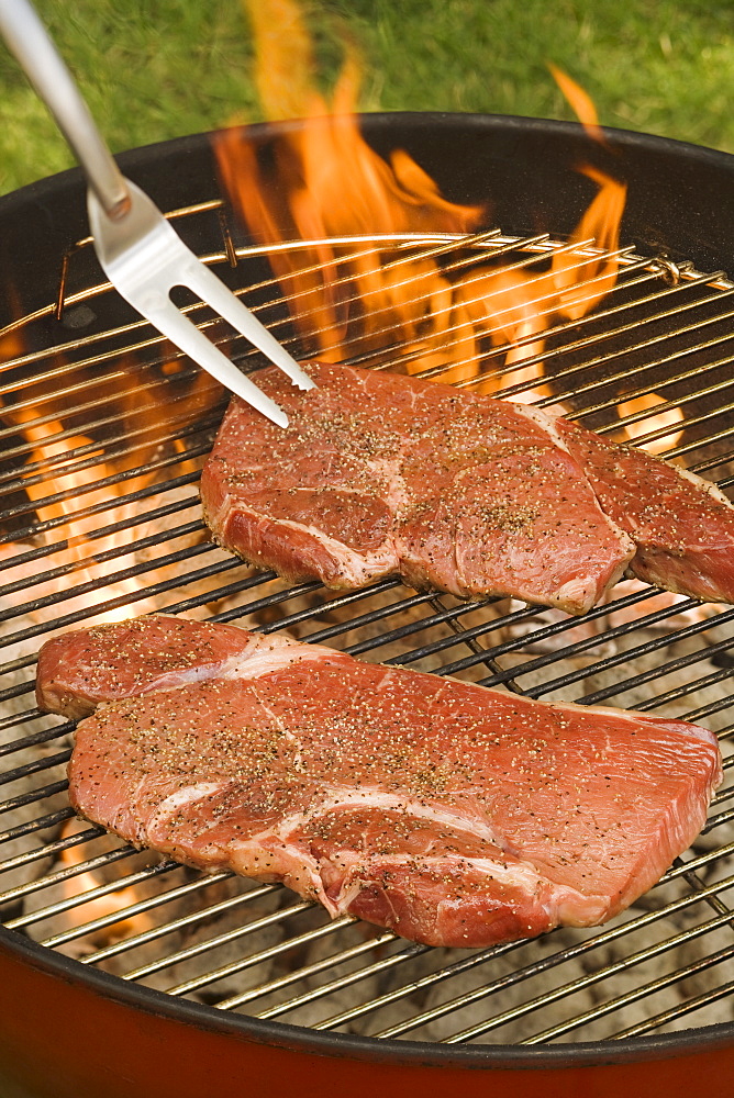 Steaks cooking on grill