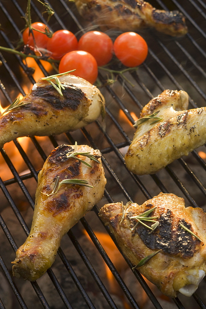 Chicken pieces cooking on grill