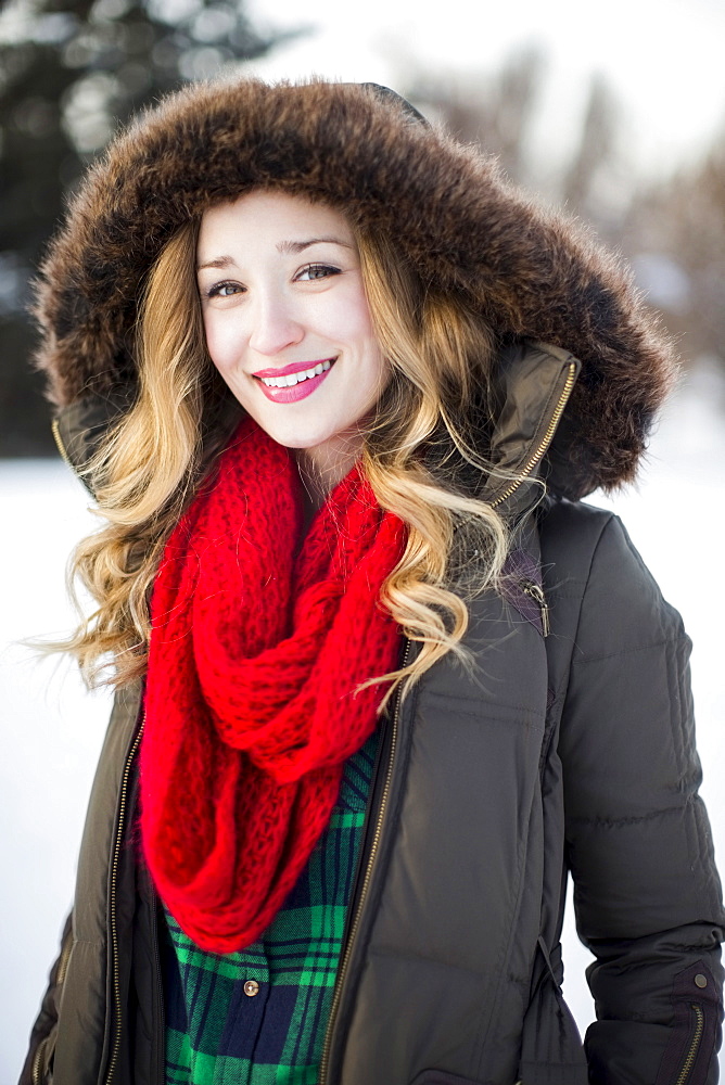 Portrait of woman wearing red scarf smiling outdoors