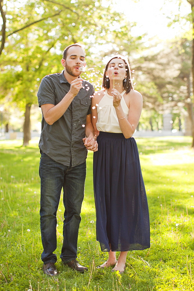 Happy young couple blowing bubbles, USA, Utah, Salt Lake