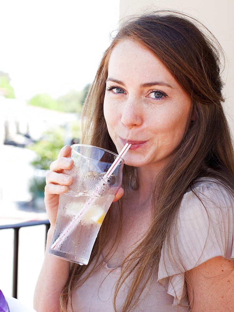 Portrait of young woman drinking water, USA, Utah, Salt Lake