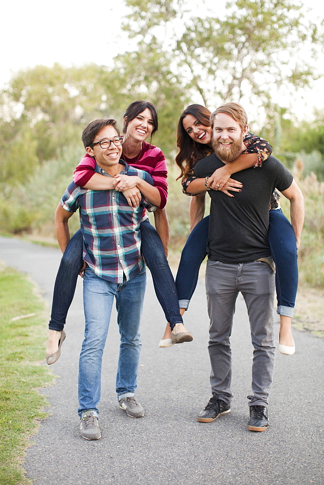 Portrait of group of friends piggy-backing, Salt Lake City, Utah