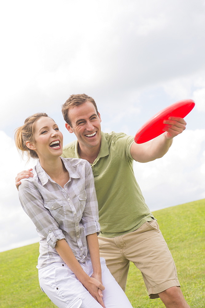 Couple playing with frisbee, USA, New Jersey, Mendham