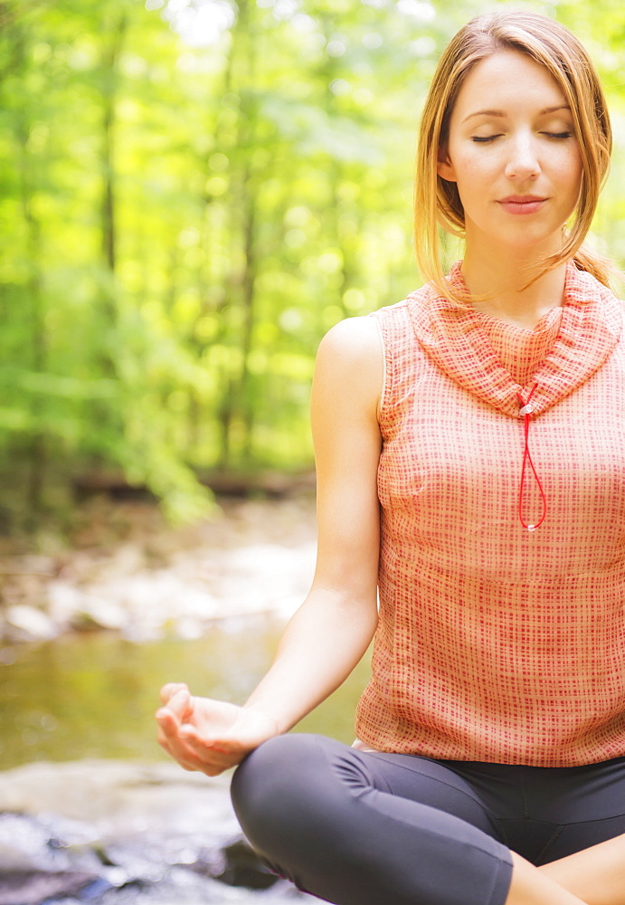 Woman practicing joga in forest, USA, New Jersey, Mendham
