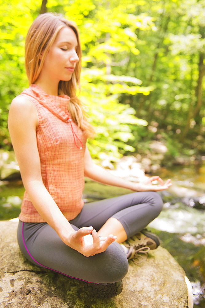 Woman practicing joga in forest, USA, New Jersey, Mendham