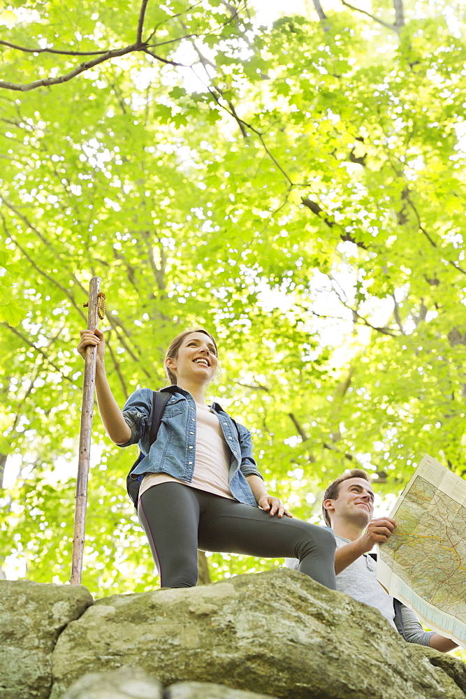 Couple hiking with map in forest, USA, New Jersey, Mendham