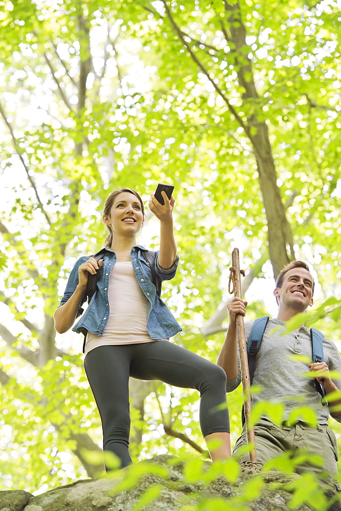 Couple hiking with GPS in forest, USA, New Jersey, Mendham