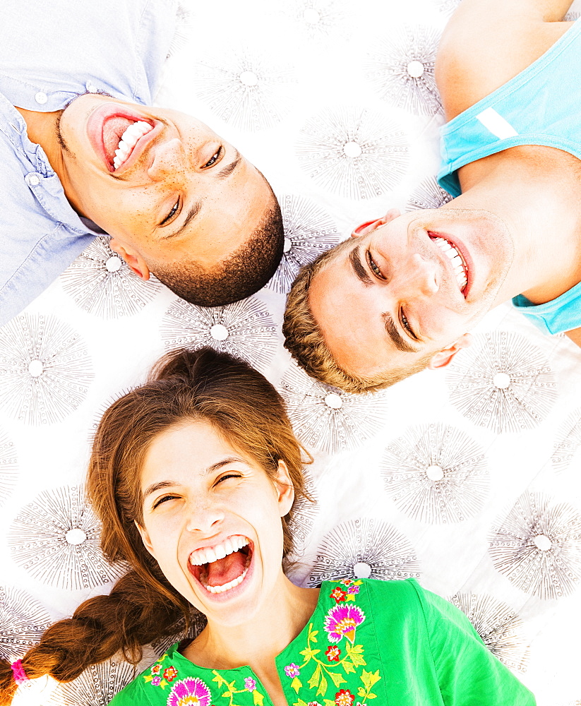Young people lying down and laughing