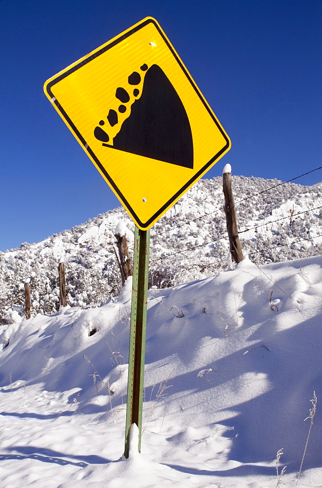 View of road sign and snowcapped mountain, Colorado