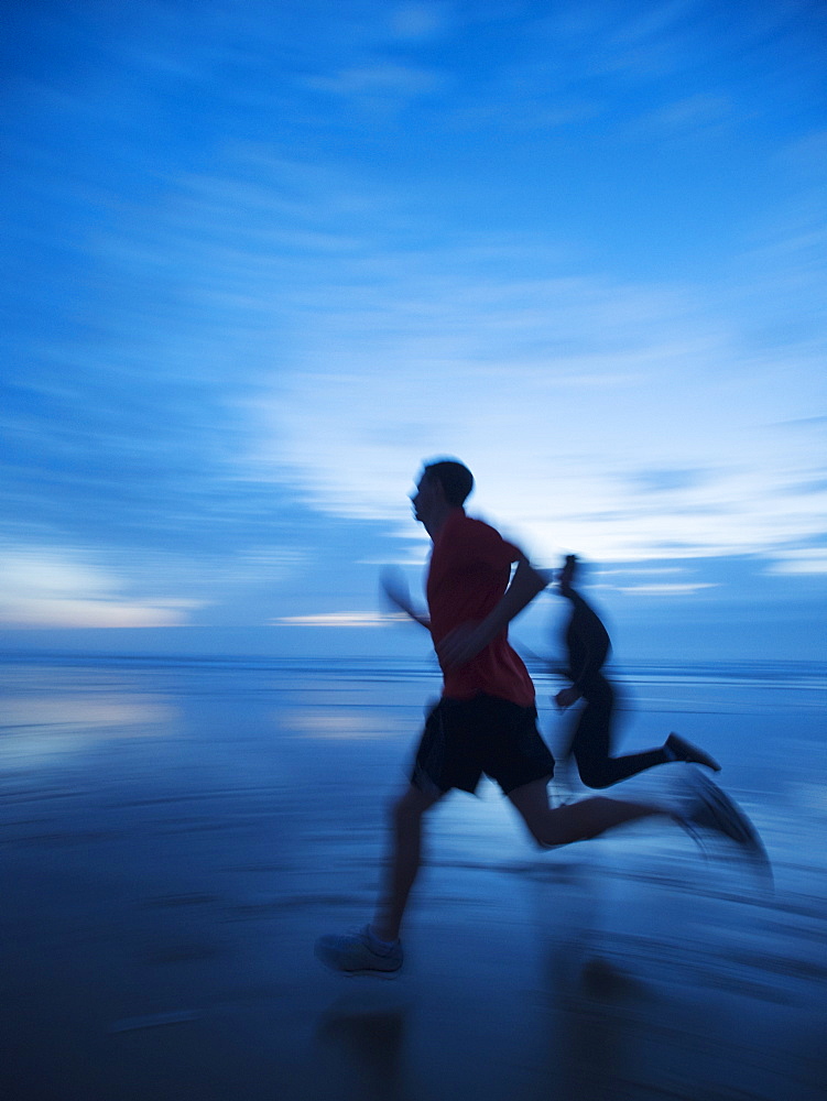 Man running along beach, Rockaway Beach, Oregon