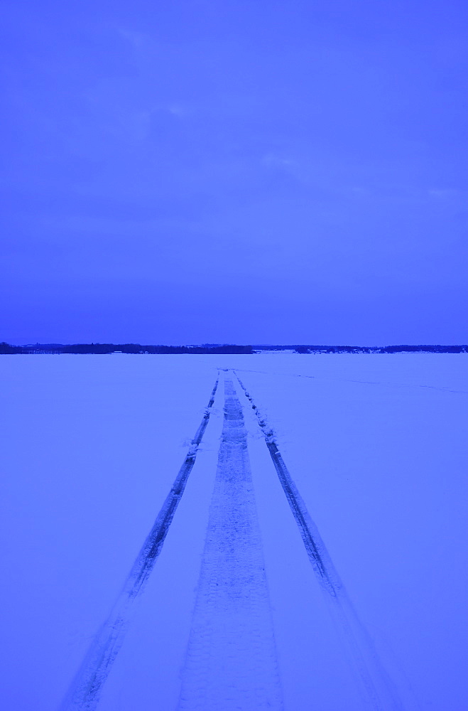 Snowmobile tracks on frozen lake, USA, New York State, Lake Champlain