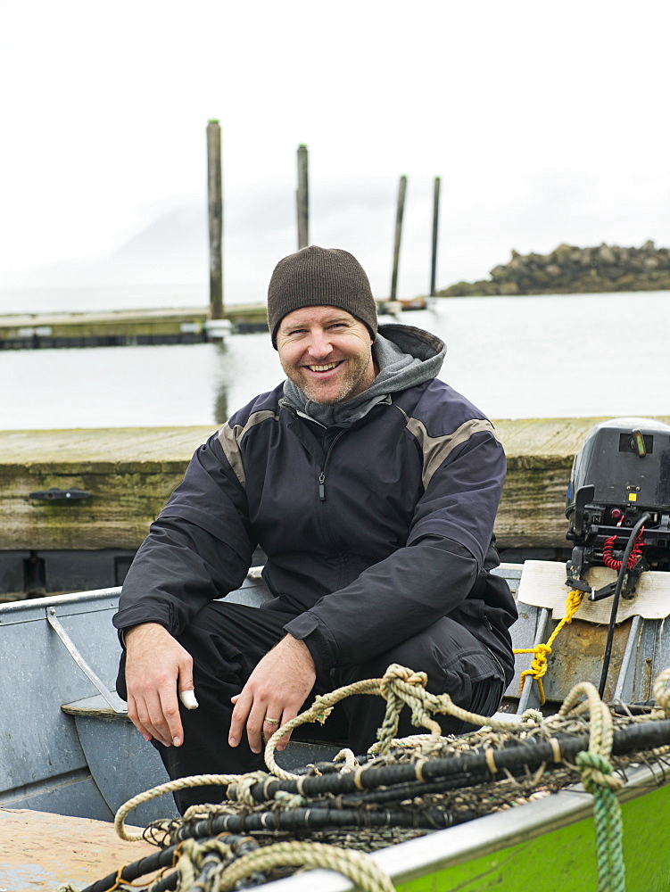 Portrait of man in boat, Rockaway Beach, Oregon