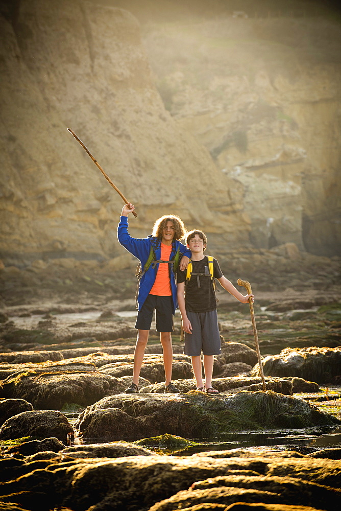 Teenage boys on rocks by tide pool in La Jolla, California