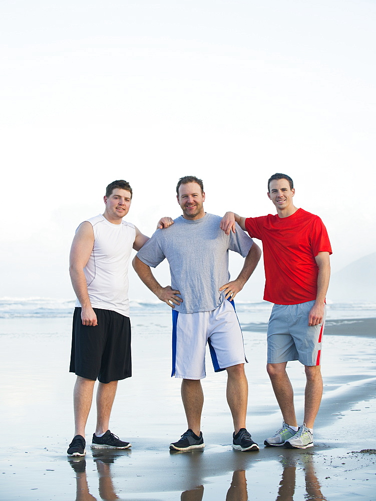 Portrait of men on beach, Rockaway Beach, Oregon