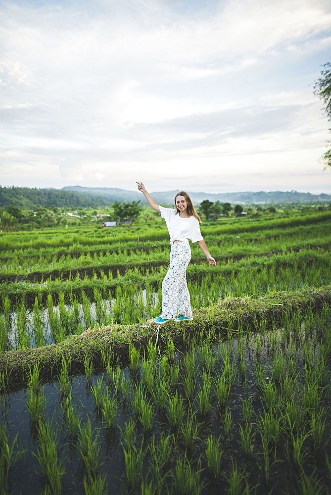 Woman walking in rice paddy in Bali, Indonesia