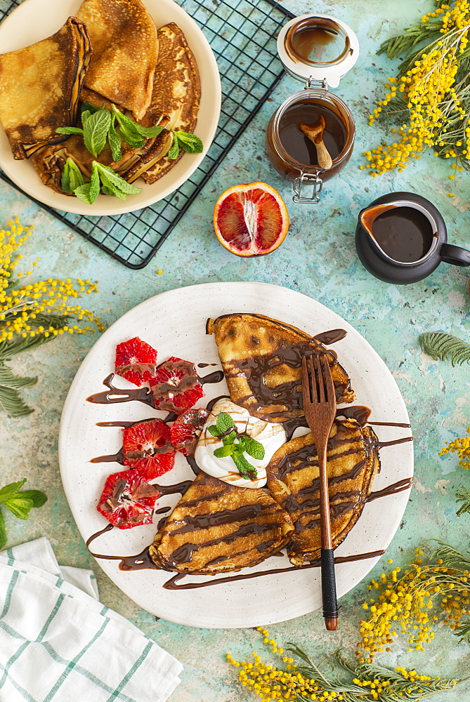 Crepes with chocolate sauce and blood oranges