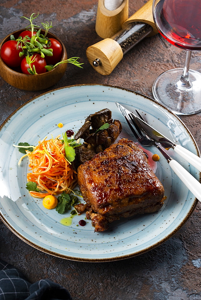 Grilled meat with salad by glass of red wine