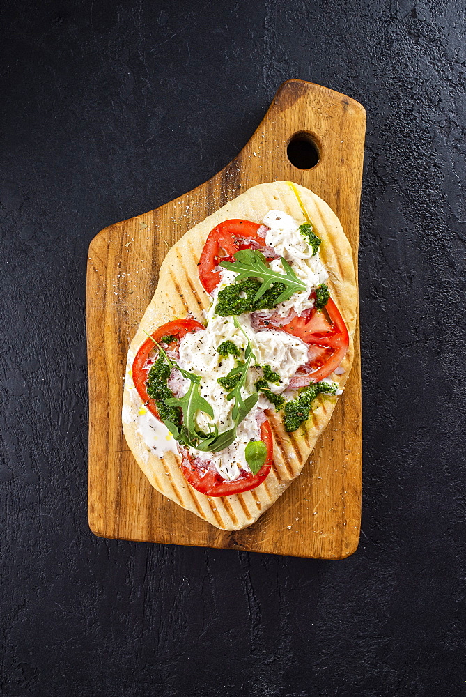 Bread topped with tomato and fish