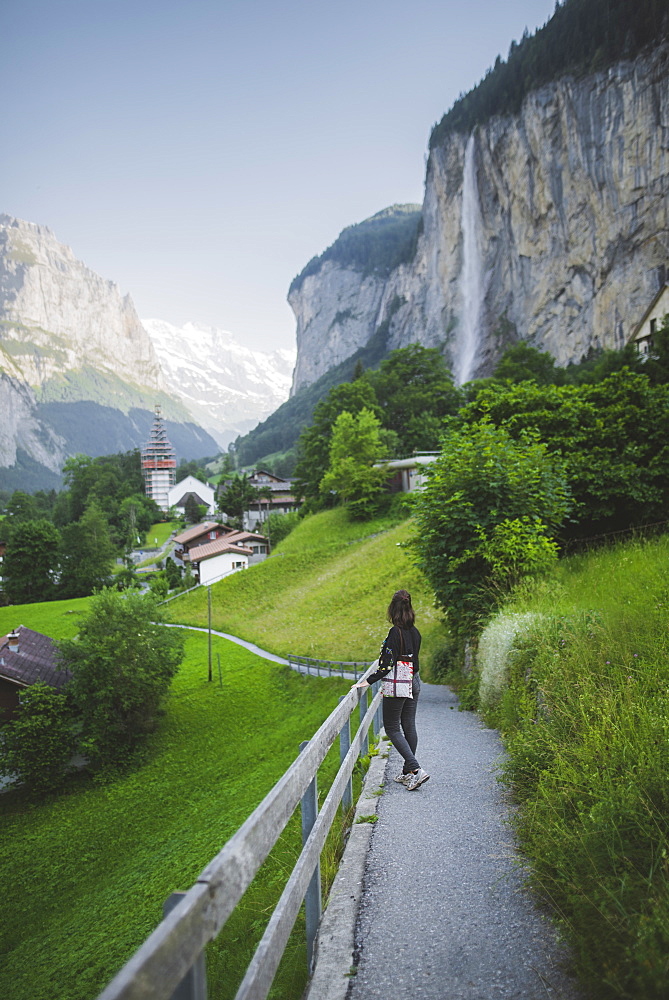 Young woman on path by mountain