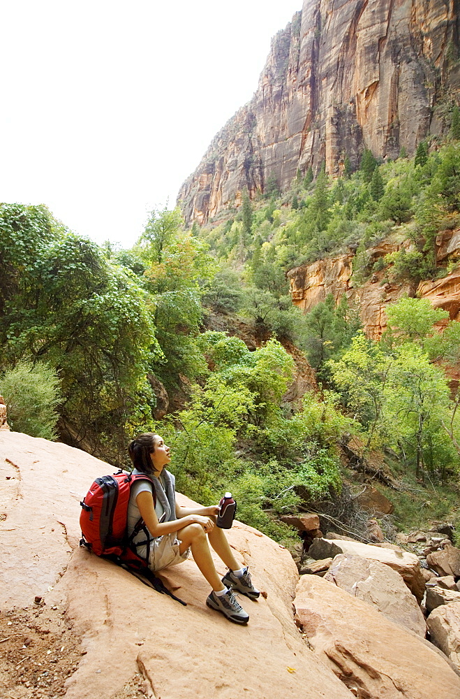 Female hiker resting on a rock