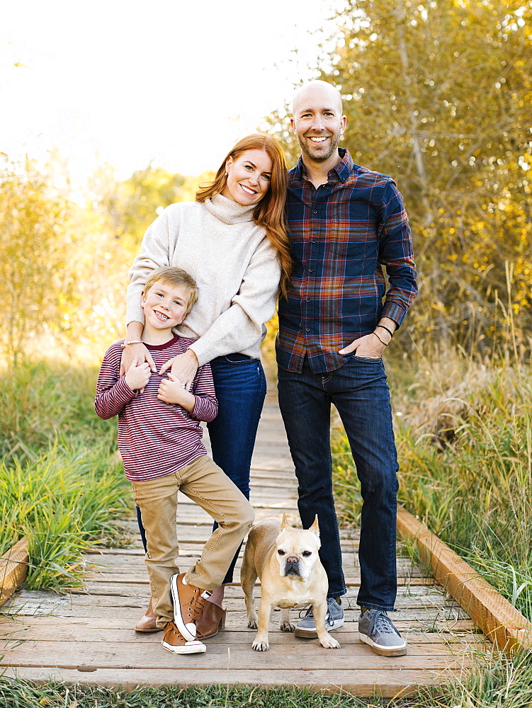 Smiling family on forest boardwalk