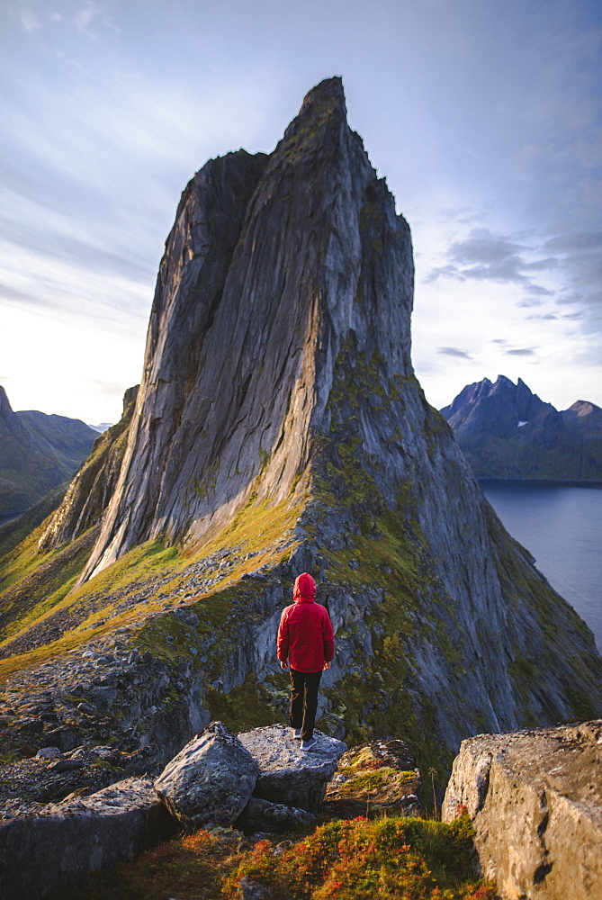 Norway, Senja, Man standing in front of Segla mountain at sunrise