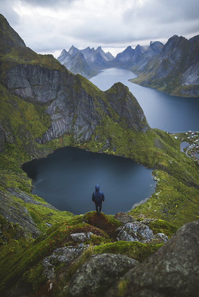 Norway, Lofoten Islands, Reine, Man looking at view from Reinebringen mountain 