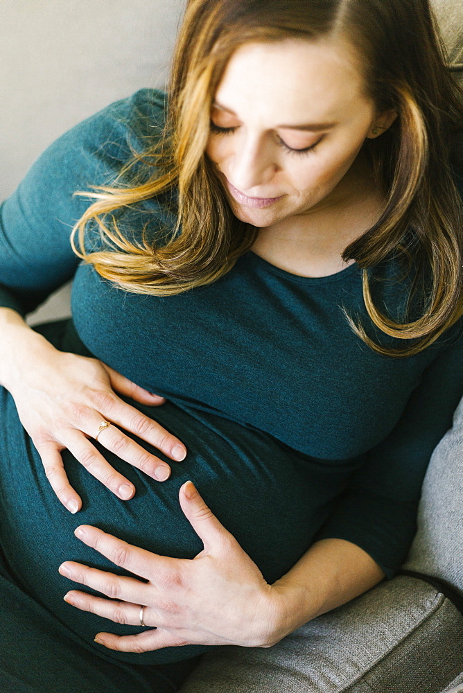 Pregnant woman touching belly