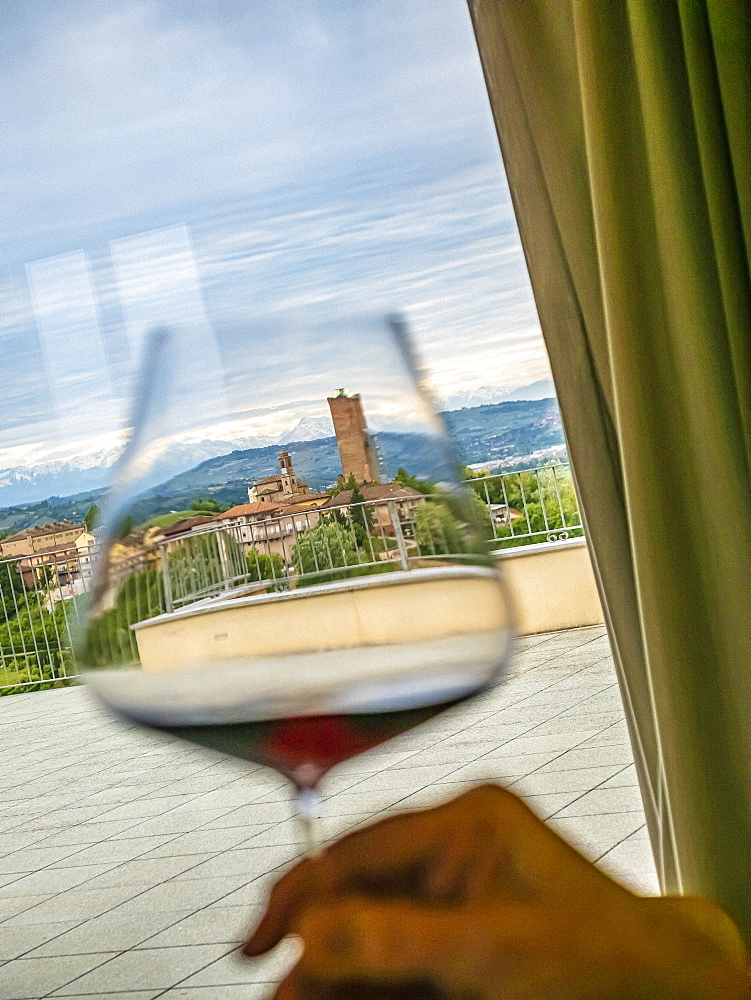 Italy, Barbaresco, Hand holding glass with barbaresco wine