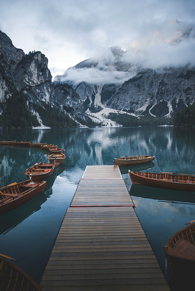 Italy, Wooden boats moored by pier at Pragser Wildsee in Dolomites