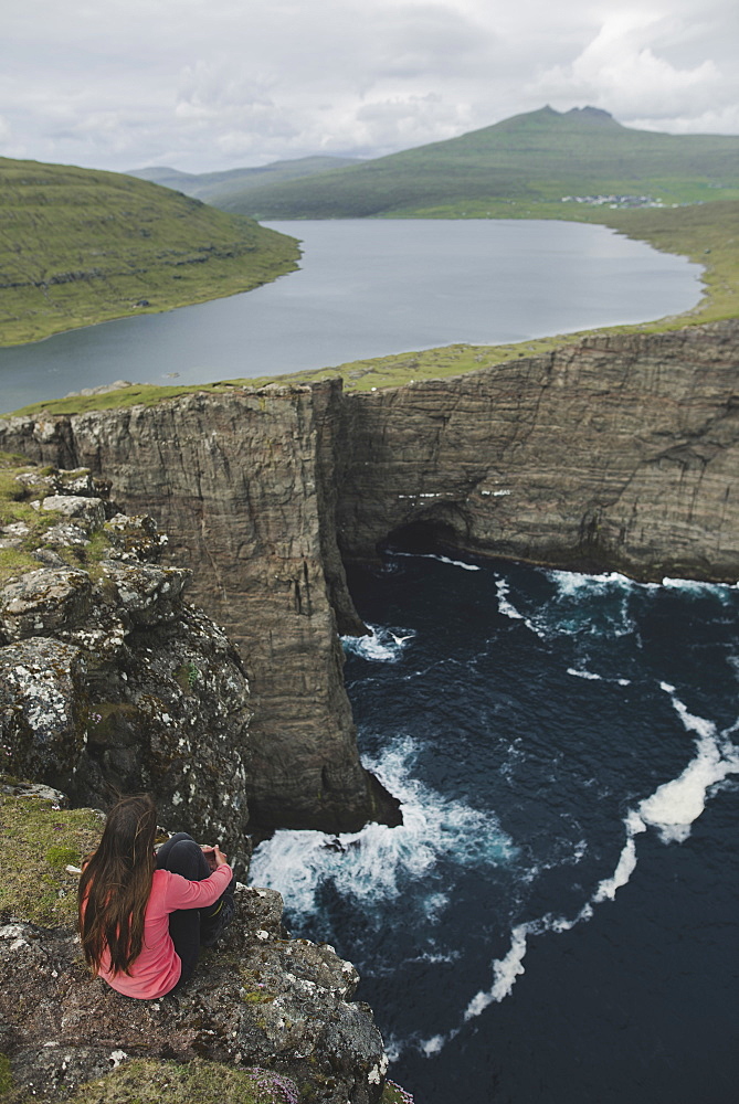 Denmark, Faroe Islands, Sorvagsvatn lake, Woman looking at dramatic landscape