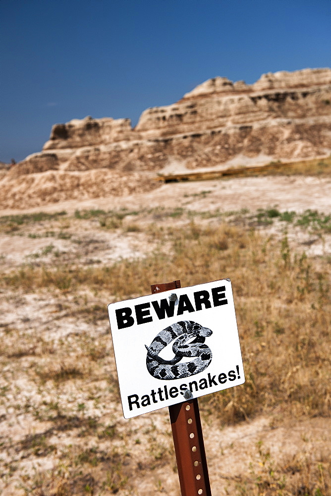 USA, South Dakota, Badlands National Park, Beware of Rattlesnakes sign in Badlands National Park