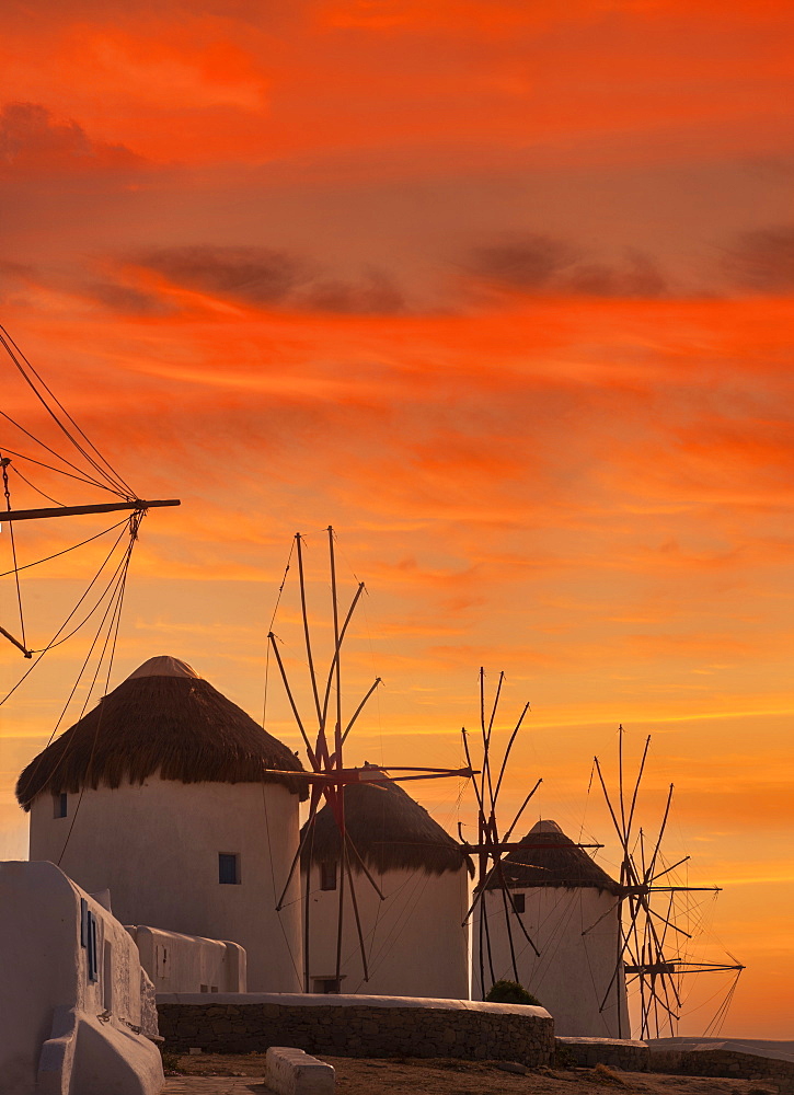 Greece, Cyclades Islands, Mykonos, Chora, Whitewashed windmills against sunset sky
