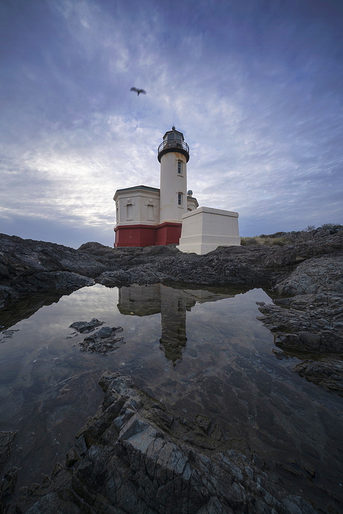 United States, Oregon, Coquille River Lighthouse reflecting in water