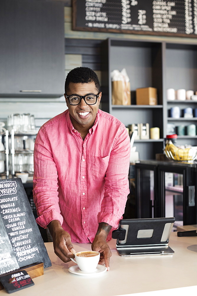 Coffee shop barista serving coffee