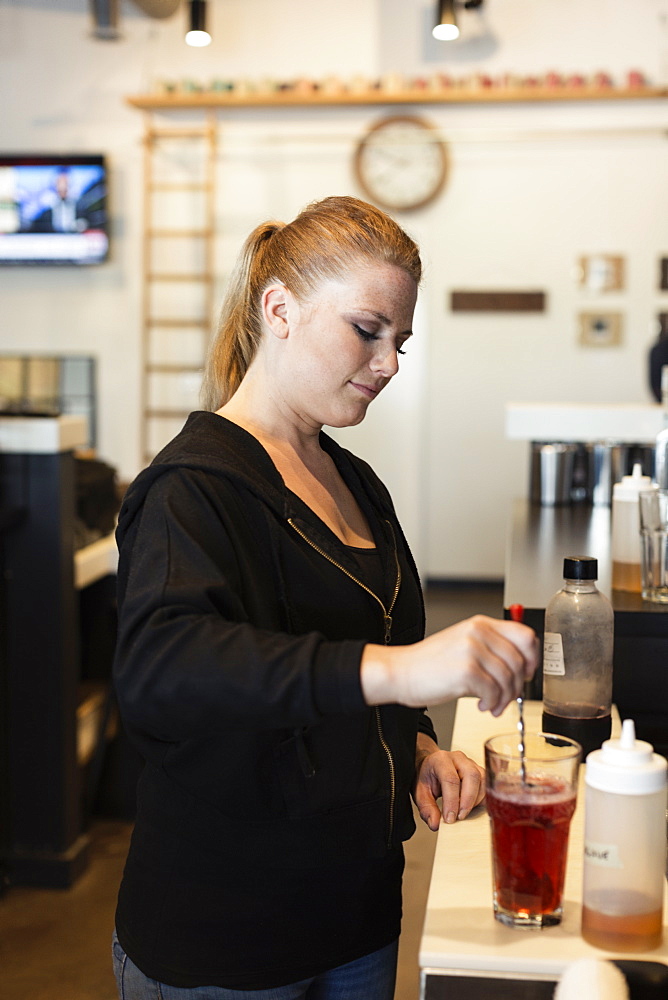 Coffee shop barista making fruit tea