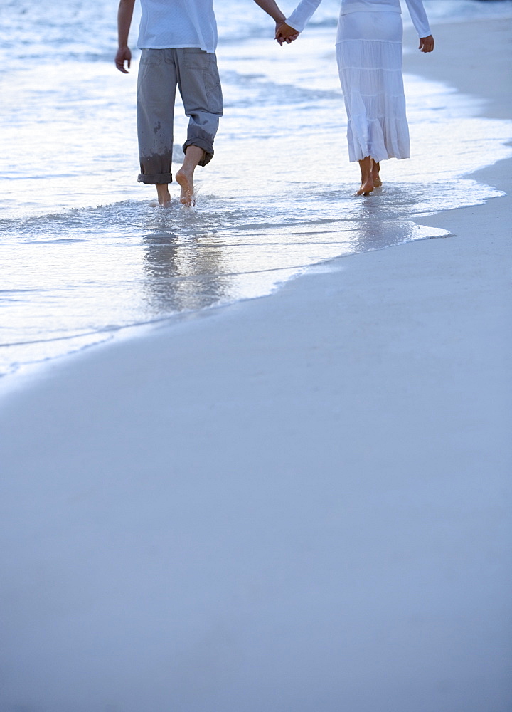 Couple walking along a beach